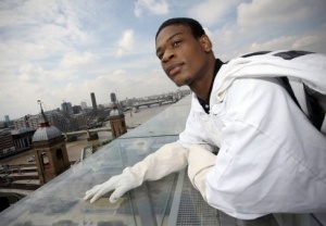 Ezekiel in beekeeper suit looking out from a rooftop over King's Cross